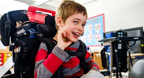 Smiling young boy in a wheelchair