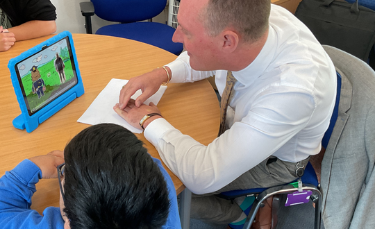 a man and a child watching an ipad