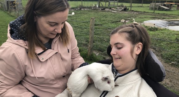 Young girl with white guinea pig