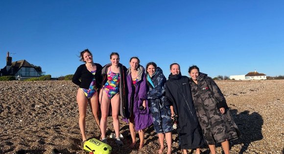 6 women on the beach in swimming suits