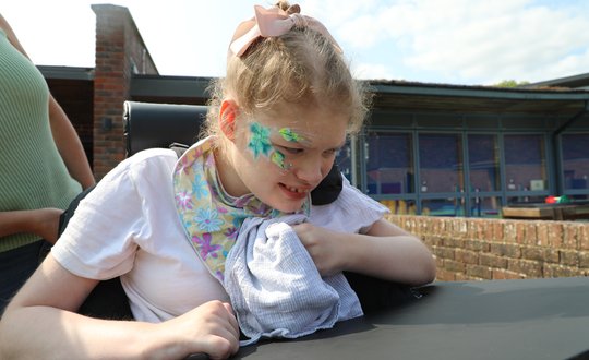 Girl with flower face painting on