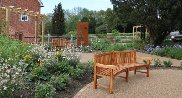 bench and flowers in garden of celebration