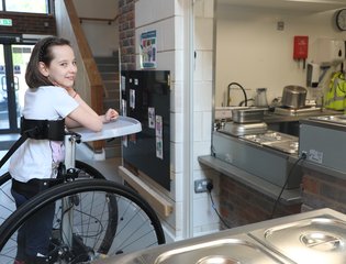young girl outside a kitchen window