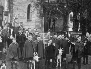 A black and white photo of young people with animals