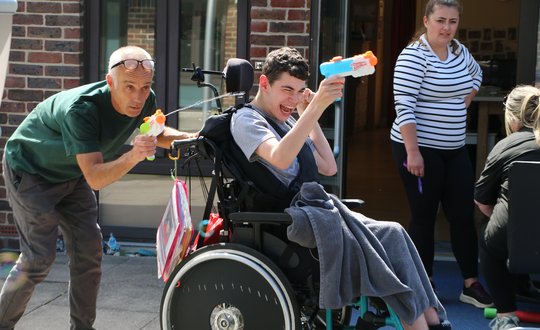 Young person playing with water pistol