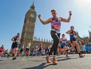 A male runner celebrating in front of Big Ben